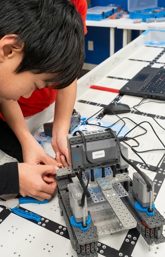 Student building a VEX IQ robot at RoboEDU Richmond
